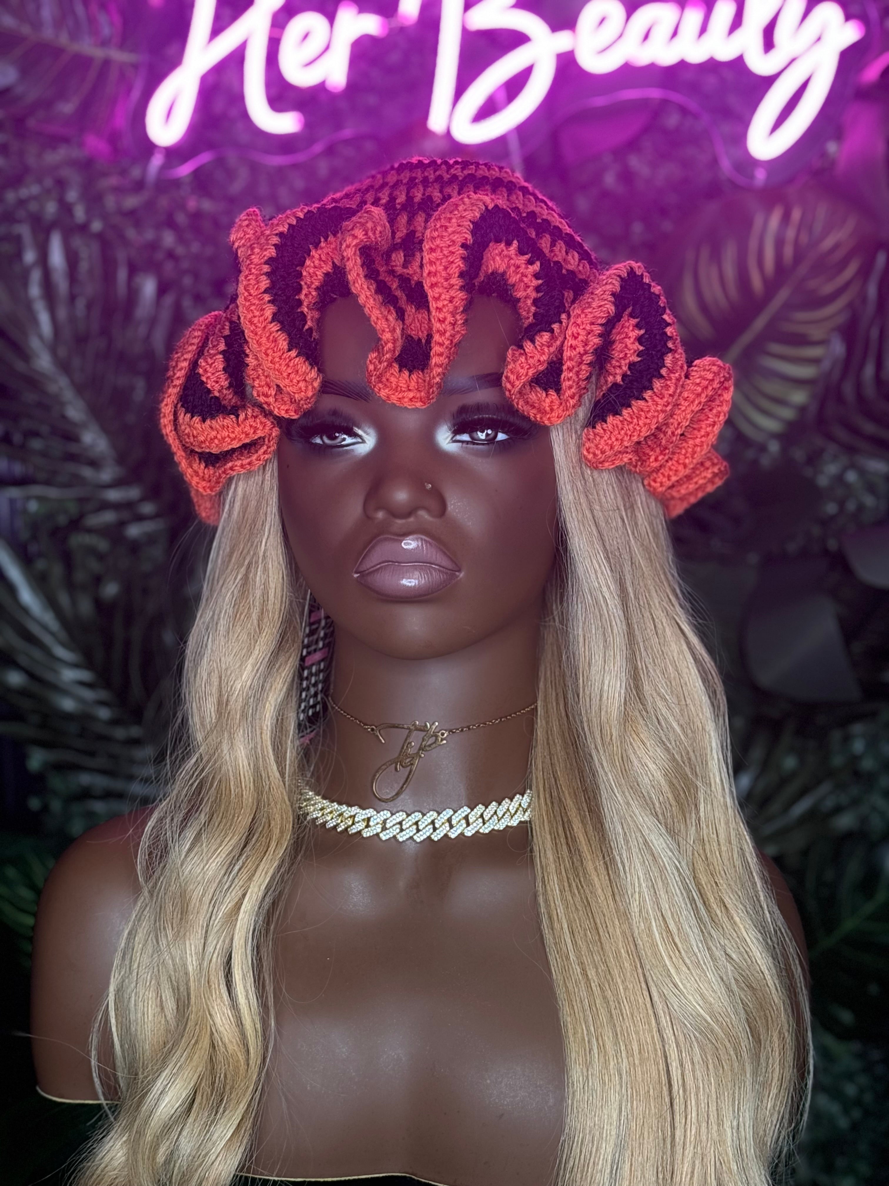 Handmade ruffled crochet hat in pink and beige with playful brim and cozy design
