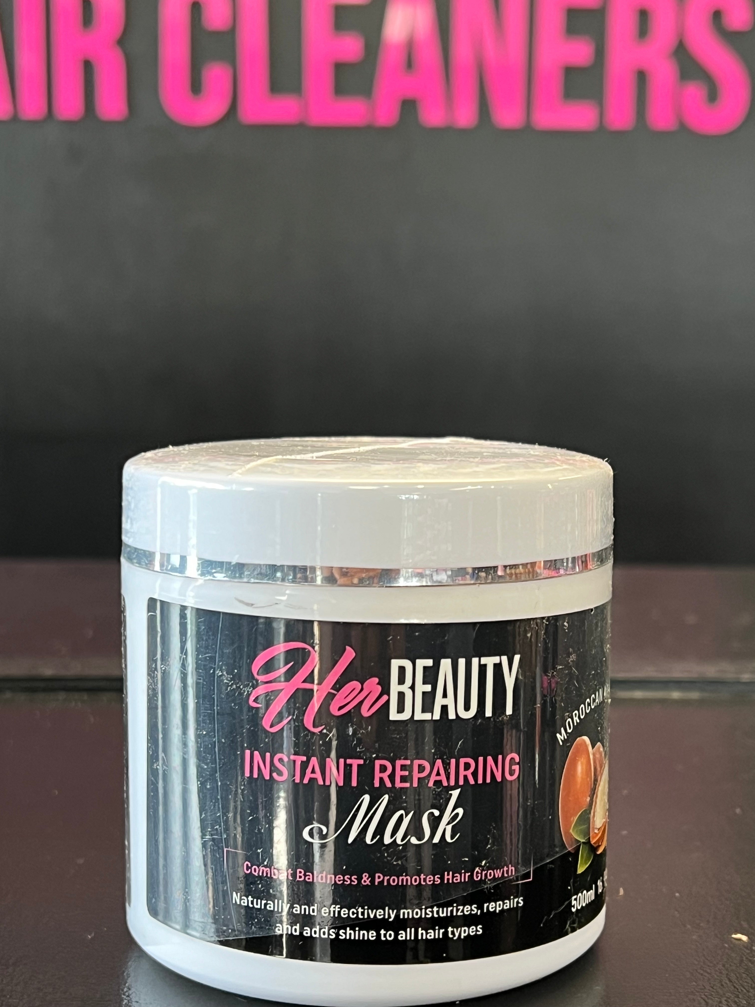 Open jar of creamy hair mask next to natural ingredients like coconut and argan oil, ideal for dry and damaged hair